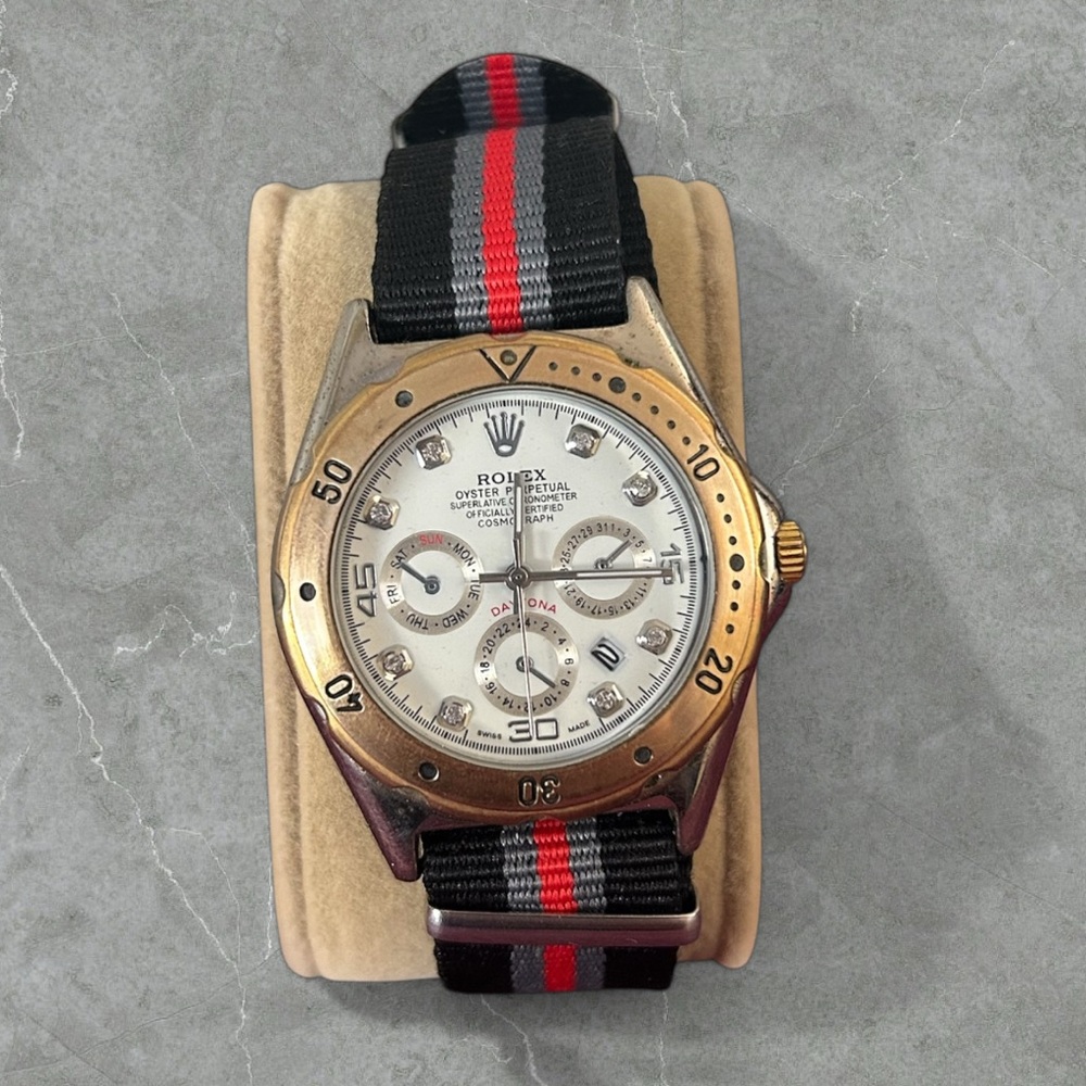 Rolex Gold and Black Watch with Red Stripe